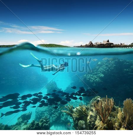Young woman snorkeling in the coral reef in the tropical Caribian sea