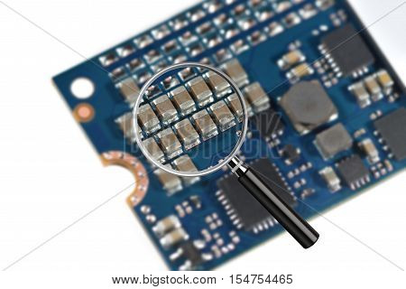 Clear image in magnifying glass against blurry close-up of a high speed M2 SSD storage drive isolated on white