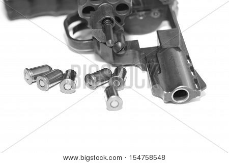 Revolver with bullets close-up isolated on white background / black and white photo in a retro style