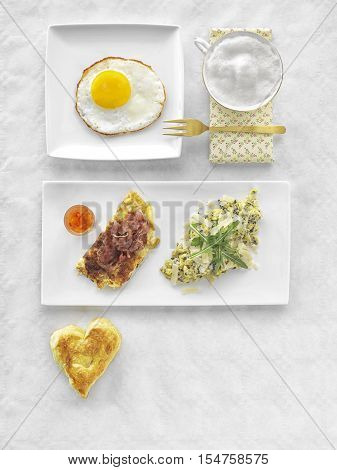 Fresh Continental Breakfast. Healthy Different Food. Scrambled Eggs, Salad, Cheese, Prosciutto, Coffee and Juice. Concept of Business or Vacation Breakfast. View from Above.