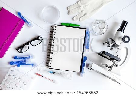 medical student working place with blank open notebook space for text top view