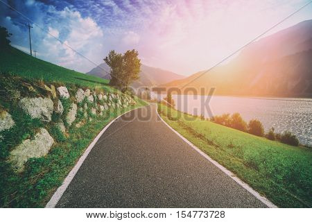 Beautiful view of the bike road on lake Resia, Alps, Italy, Europe. Toned like Instagram filter