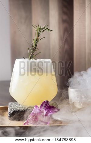 Cocktail with form topping and smoke from dry ice