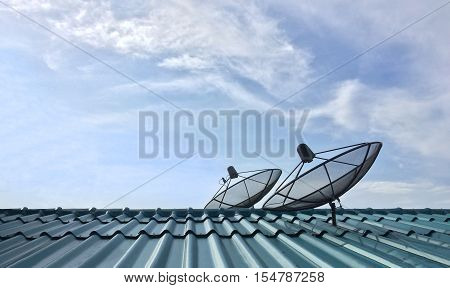 Two satellite dish receive signals from another station in space is part of Satellite communication systems for mobile phone, TV channel, Internet and other dish of households on rooftop