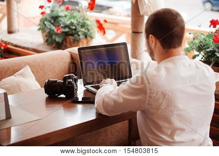 Man Is Looking At Laptop With Excitement.