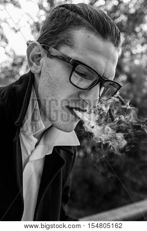 handsome guy with glasses reading a newspaper