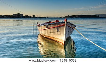 Lonely boat at the pier of Eretria port in Greek island Evia