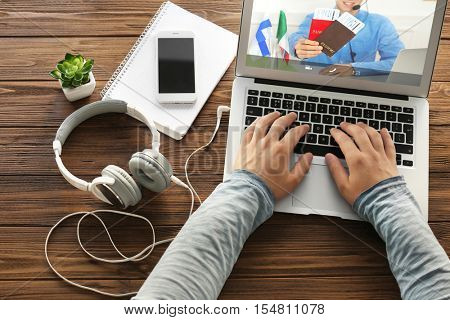 Video call and chat concept. Man video conferencing with travel agent on laptop.