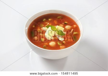 Homemade delicious minestrone soup with cheese and basil