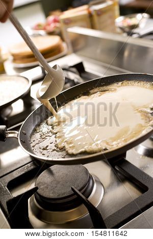 pancakes cooking on the hot stove griddle. Shallow depth of field.