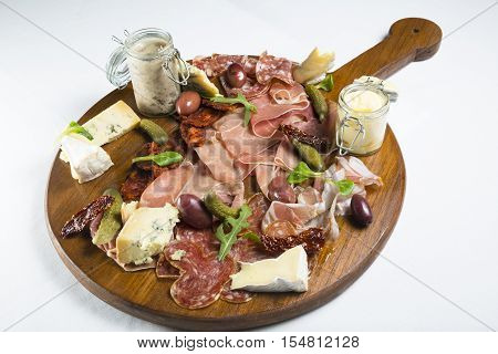 Various food in Charcuterie board on dining table