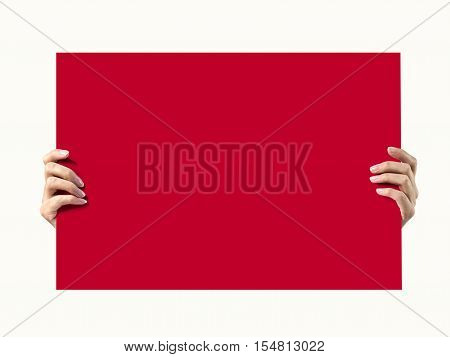 Woman hands holding a piece of red paper. Isolated on white.