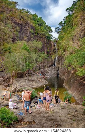 Koh Chang, Thailand - December 20, 2015: Realistic image of lots of tourists in the Khlong Phlu Waterfall Mu Koh Chang National Park. Unidentified people admiring the waterfall swim and take photos.