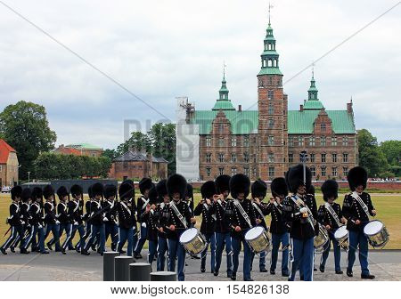 Copenhagen, Denmark - Aug 3, 2016: Royal guardsmen marching in field dress in Rosenborg slot, Denmark. Rosenborg is famous castle and museum of Copenhagen.