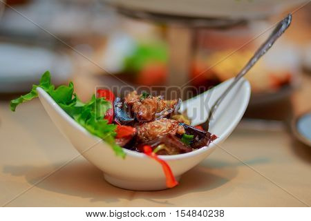 Roasted vegetables with herbs and spices on the wood backgroun dsalad of eggplant