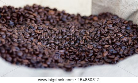 various roasted coffee beans in the foreground isolated