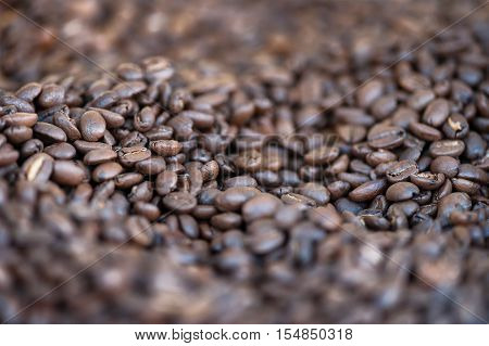 various roasted coffee beans in the foreground isolated
