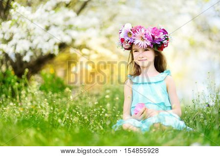 Adorable Little Girl In Blooming Cherry Garden