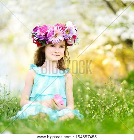 Adorable Little Girl In Blooming Cherry Garden