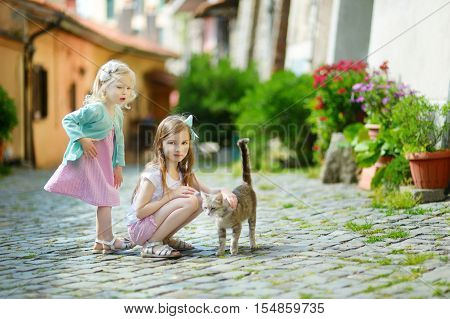 Two Adorable Little Sisters And A Cat