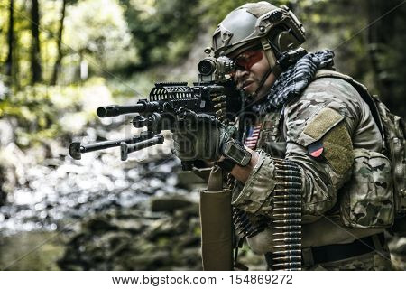 United states army ranger machine gunner in the forest
