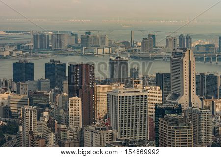 Tokyo Japan - September 26 2016: Aerial view since shot off Observatory tower. Plenty of harbor area behind multiple highrise buildings of which the tallest one is the NEC building on the right.