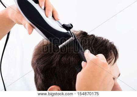 Hairdresser Cutting Person's Hair With Electric Trimmer