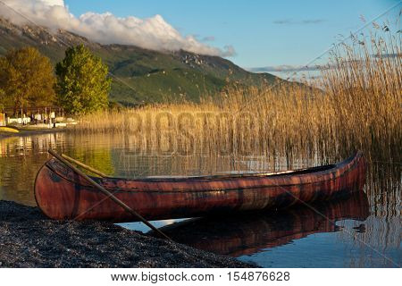 Sunset over the lake and parking the kanu boat behind the reed.
