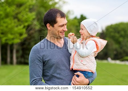 Daughter With Her Father In The Park.