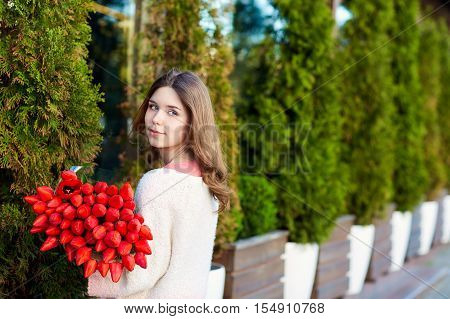 Romantic Girl With A Bouquet Of Red Tulips