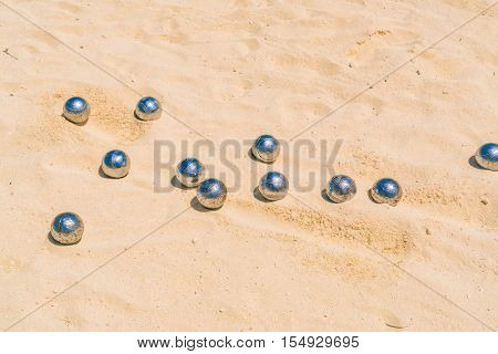 Bocce balls on white sandy beach