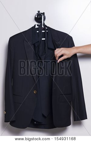 Men suit hang on the room wall