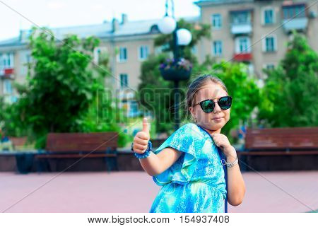 Portrait Of A Girl With Glasses On The Background Of The City