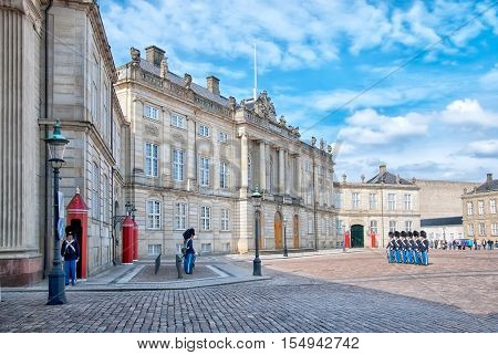 COPENHAGEN, DENMARK - APRIL 13, 2010: Changing of the Guard near the Royal Palace of Amalienborg. It is is a popular tourist attraction