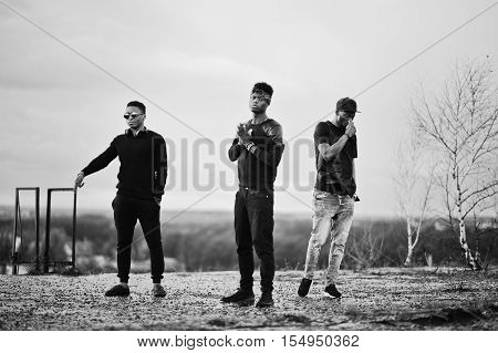 Three Rap Singers Band On The Roof. Black And White Photo