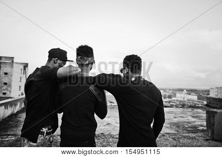 Three Rap Singers Band On The Roof. Black And White Photo