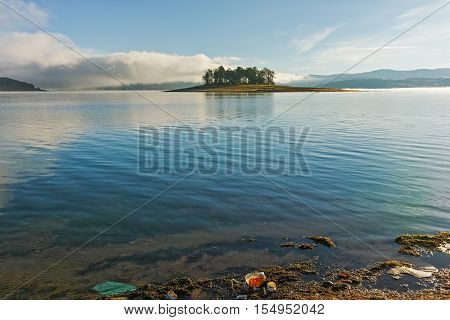 Island with pines in Batak Reservoir, Pazardzhik Region, Bulgaria