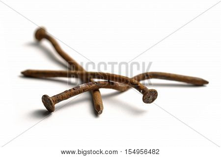 Crooked and rusty nails on a white background