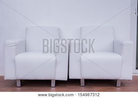 Living room with sofa in front of a wall in white