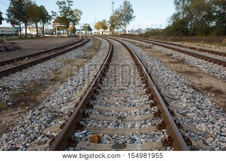 Three trails of rail road tracks near a city