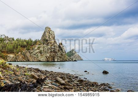 The white ship looks picturesque against the gathering clouds over lake Baykal