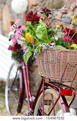 Vintage bicycle decorated with various flowers on summer day