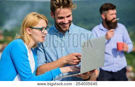 Colleagues Working Laptop, Boss Smoking While Coffee Break On Background. Colleagues With Laptop Wor