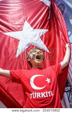 Boy and  Waving Fabric Flag of Turkey, Turkish National Flag Fabric Background Texture, Turkey Flag Blowing in the Wind, Realistic Flag of Turkey on Wavy Surface of Fabric, Fluttering Downwind