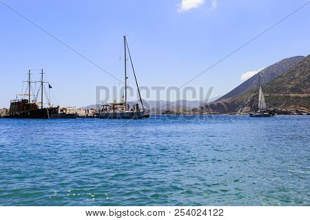 White Sailboat In The Open Mediterranean Sea On A Sunny Day. Sailing Yacht In The Open Sea With Moun