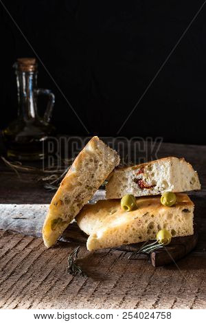 Sliced Bread Ciabatta And Extra Virgin Olive Oil On Olive Wood Cookware Background. Wooden Desk. Ita