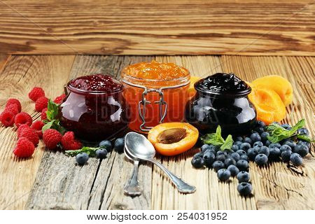 Assortment Of Jams, Seasonal Berries, Apricot, Mint And Fruits. Marmalade Or Confiture
