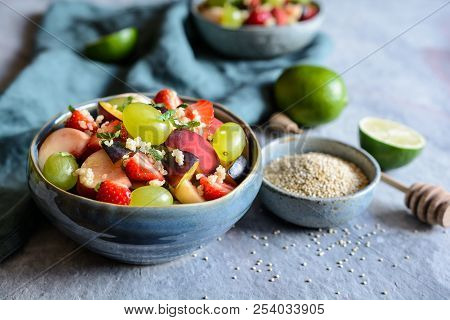 Fruit Salad With Quinoa, Strawberry, Peach, White Grapes, Plums, Mint And Honey Lime Dressing