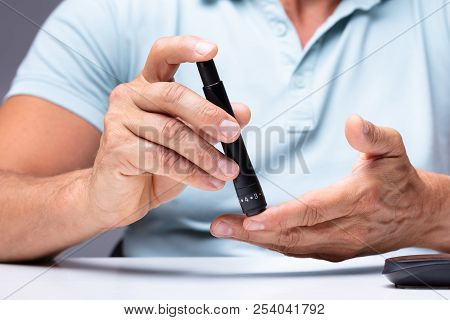 Man Testing High Blood Sugar With Glucometer