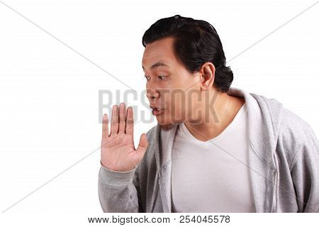 Young Asian Man Wearing Jacket Whispering And Gossiping